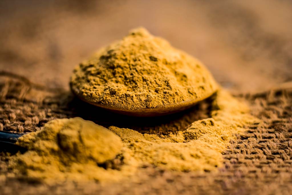 Multani Mitti (Fuller's Earth) Showcased in wooden spoon on jute bag